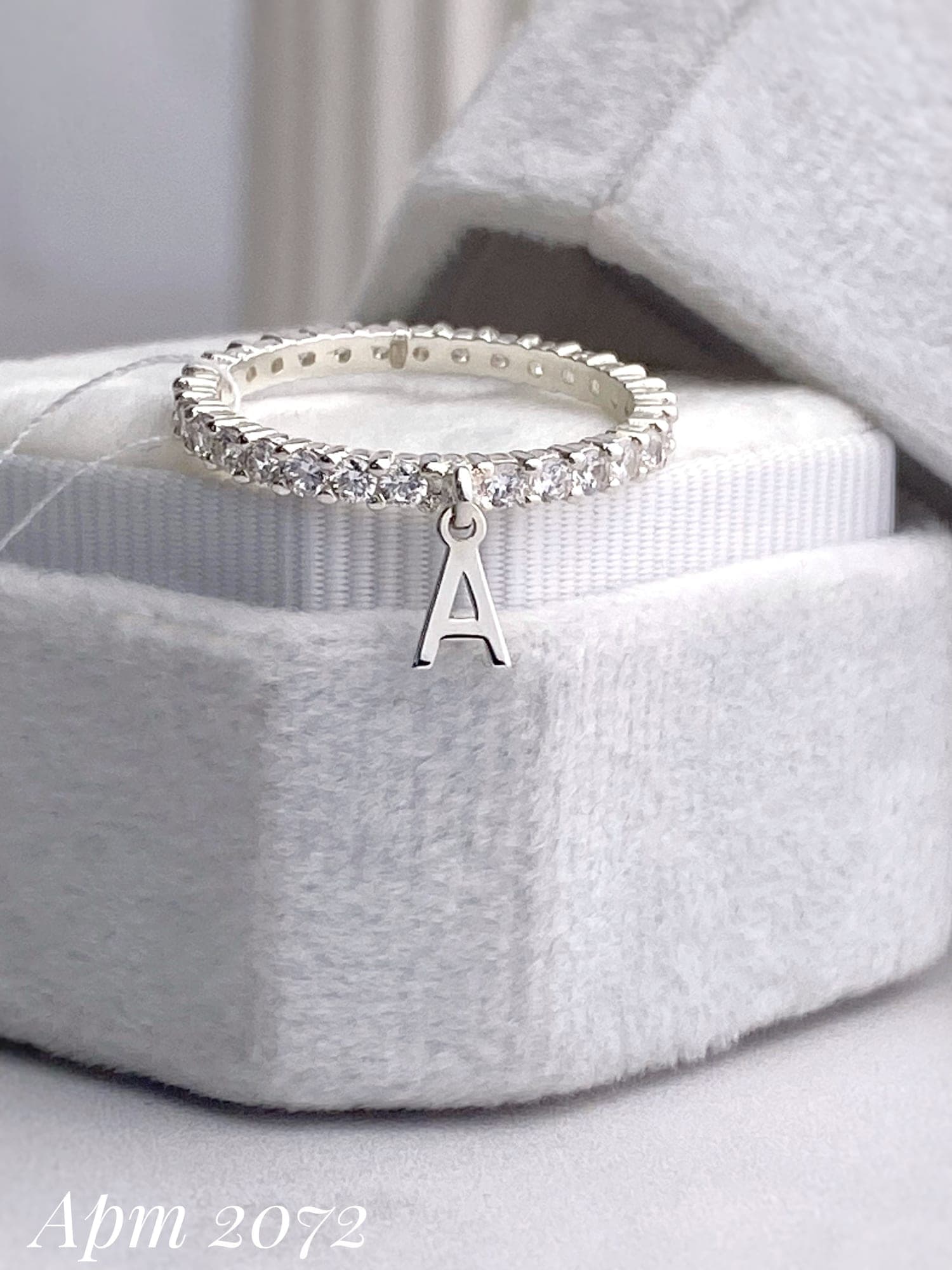 Silver ring with a letter charm