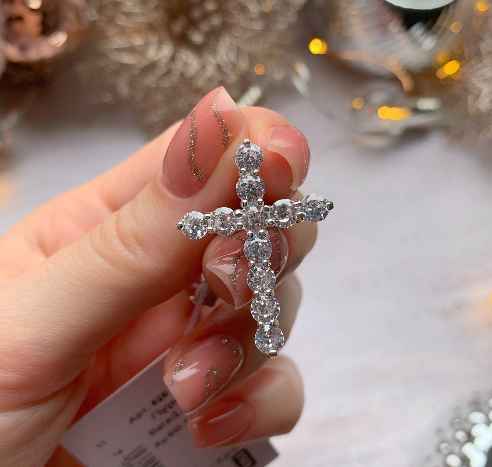Rhodium-plated silver cross pendant with a row of sparkling cubic zirconia
