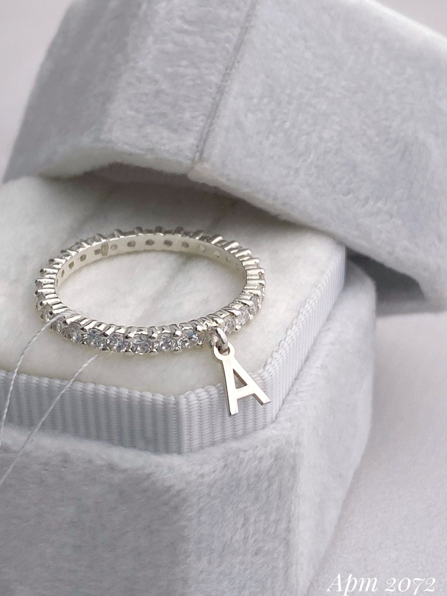 Silver ring with a letter charm