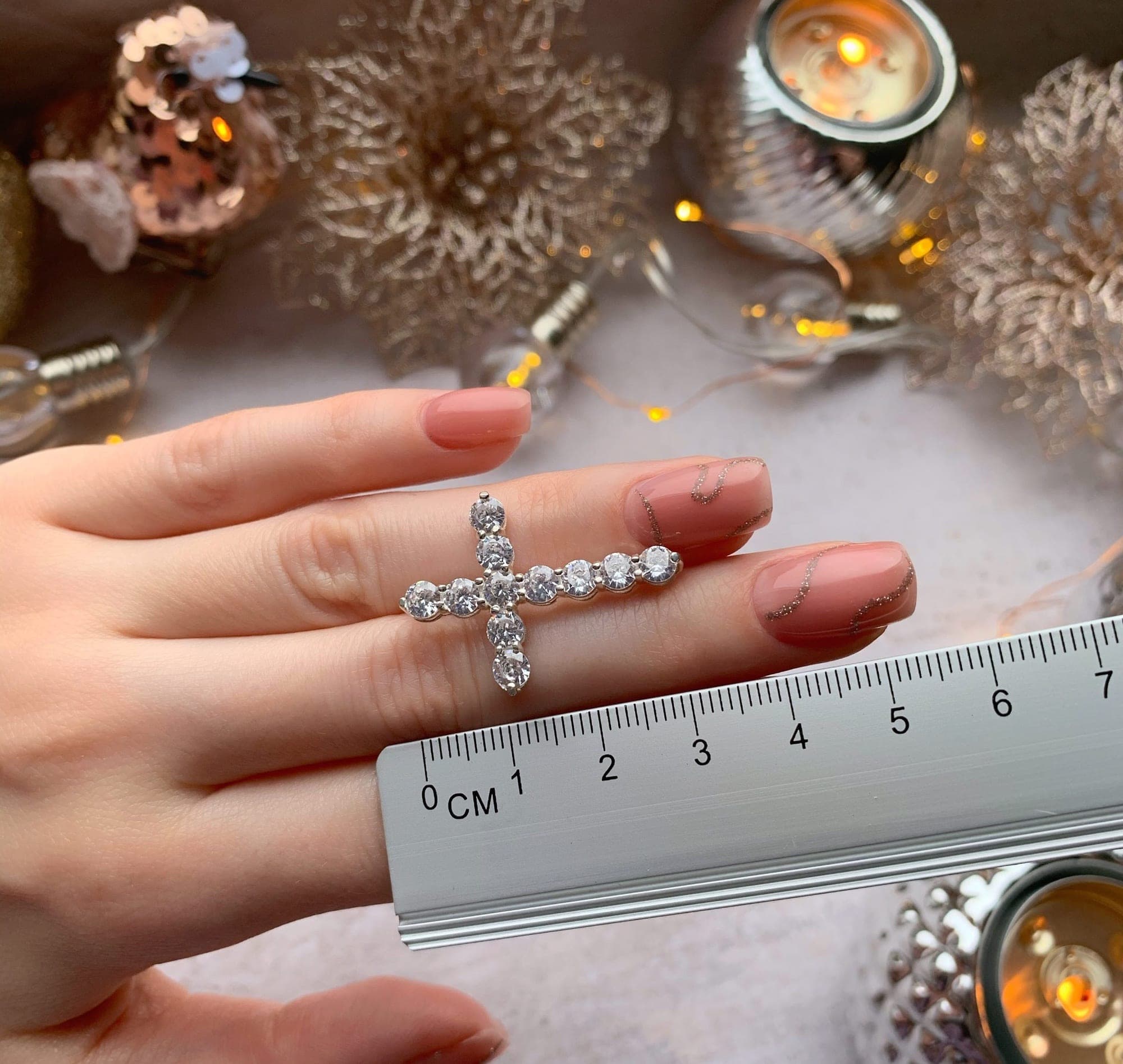 Rhodium-plated silver cross pendant with a row of sparkling cubic zirconia