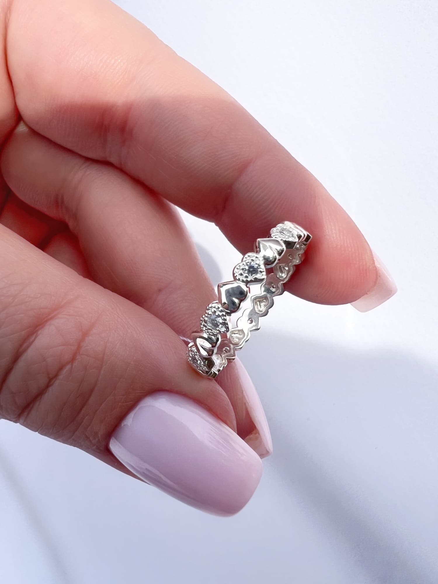 Rhodium-plated silver ring with a row of hearts and stones