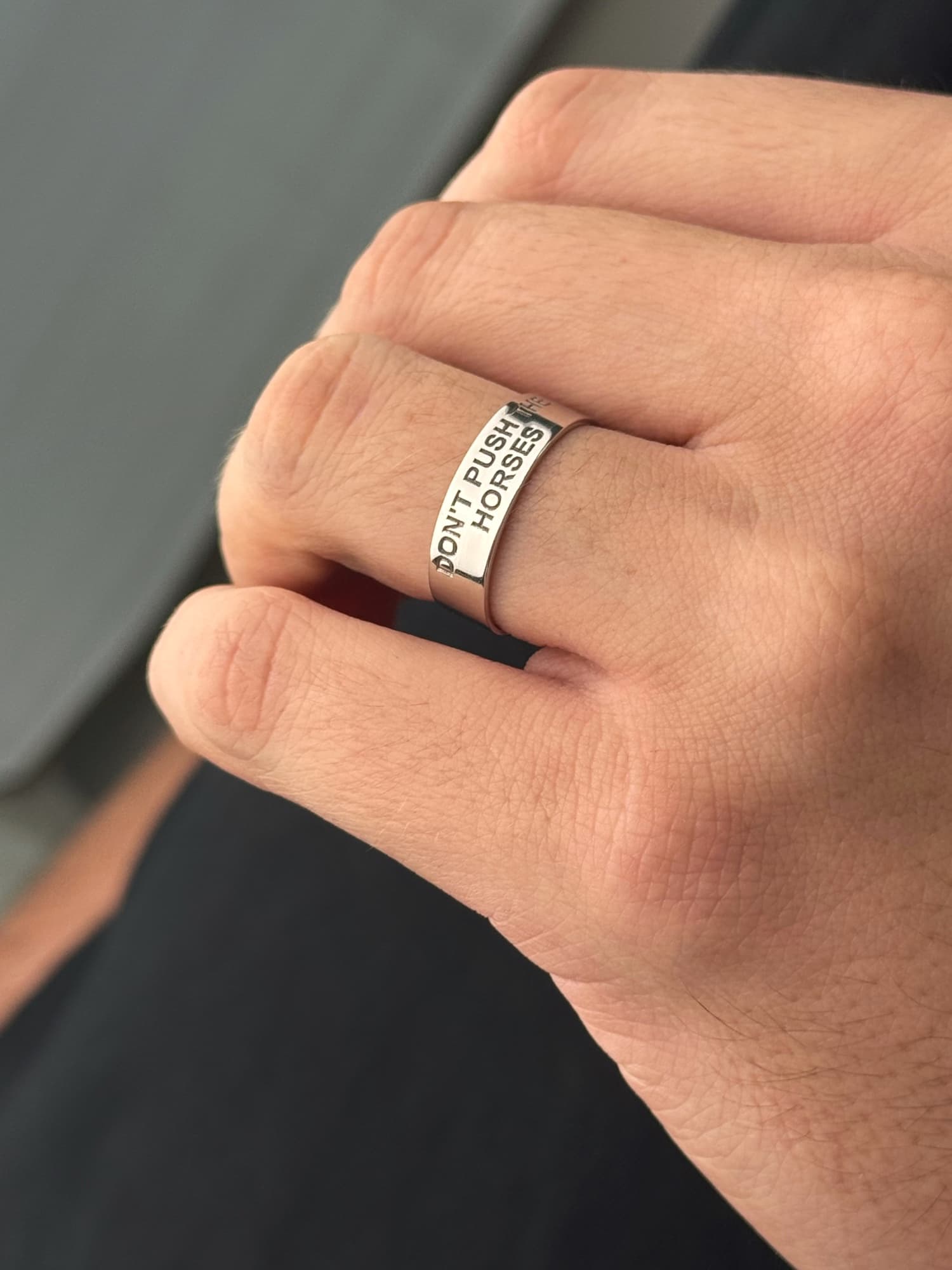 Wide men's silver ring engraved “Don't push the horses”