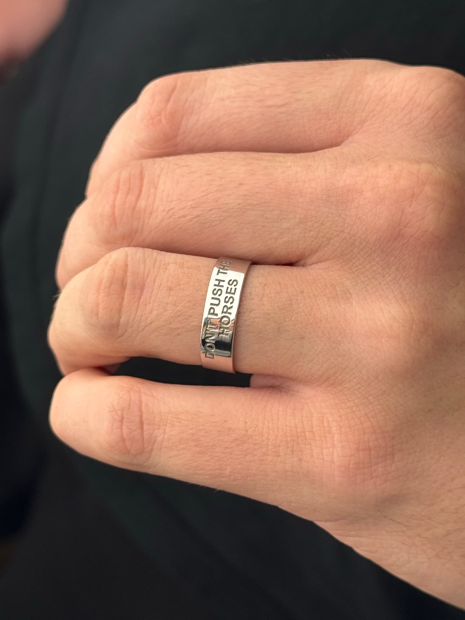 Wide men's silver ring engraved “Don't push the horses”