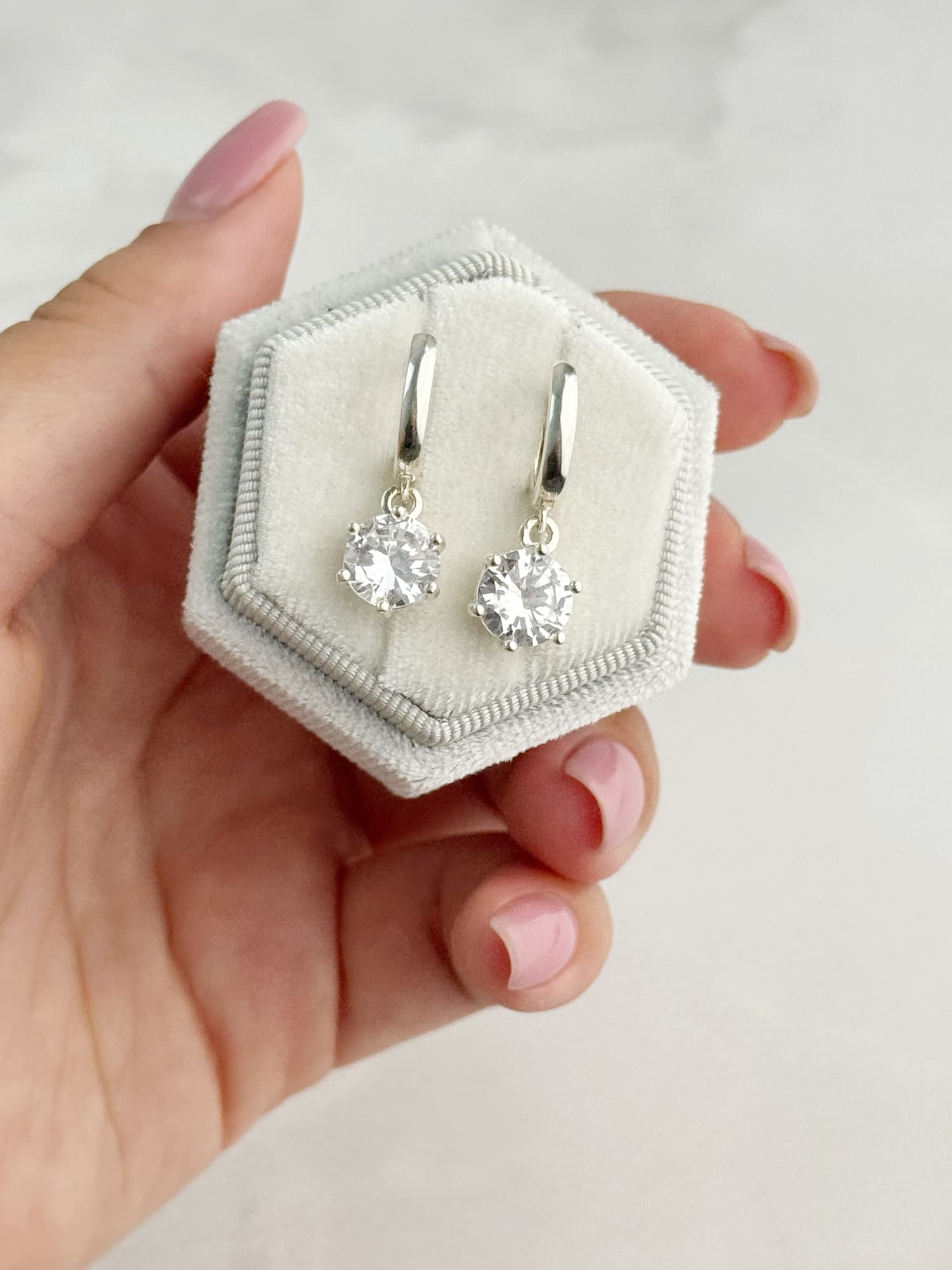 Silver earrings with round cubic zirconia drops on hoops