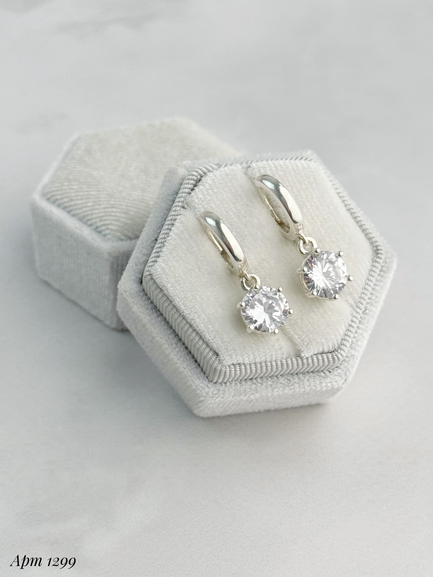 Silver earrings with round cubic zirconia drops on hoops