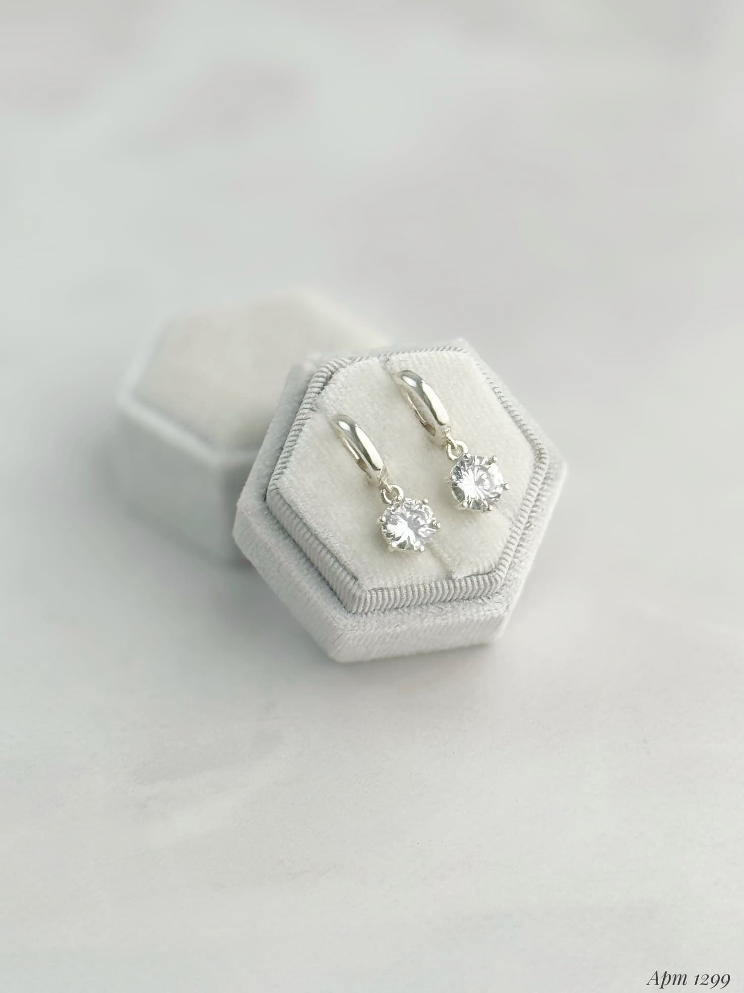Silver earrings with round cubic zirconia drops on hoops
