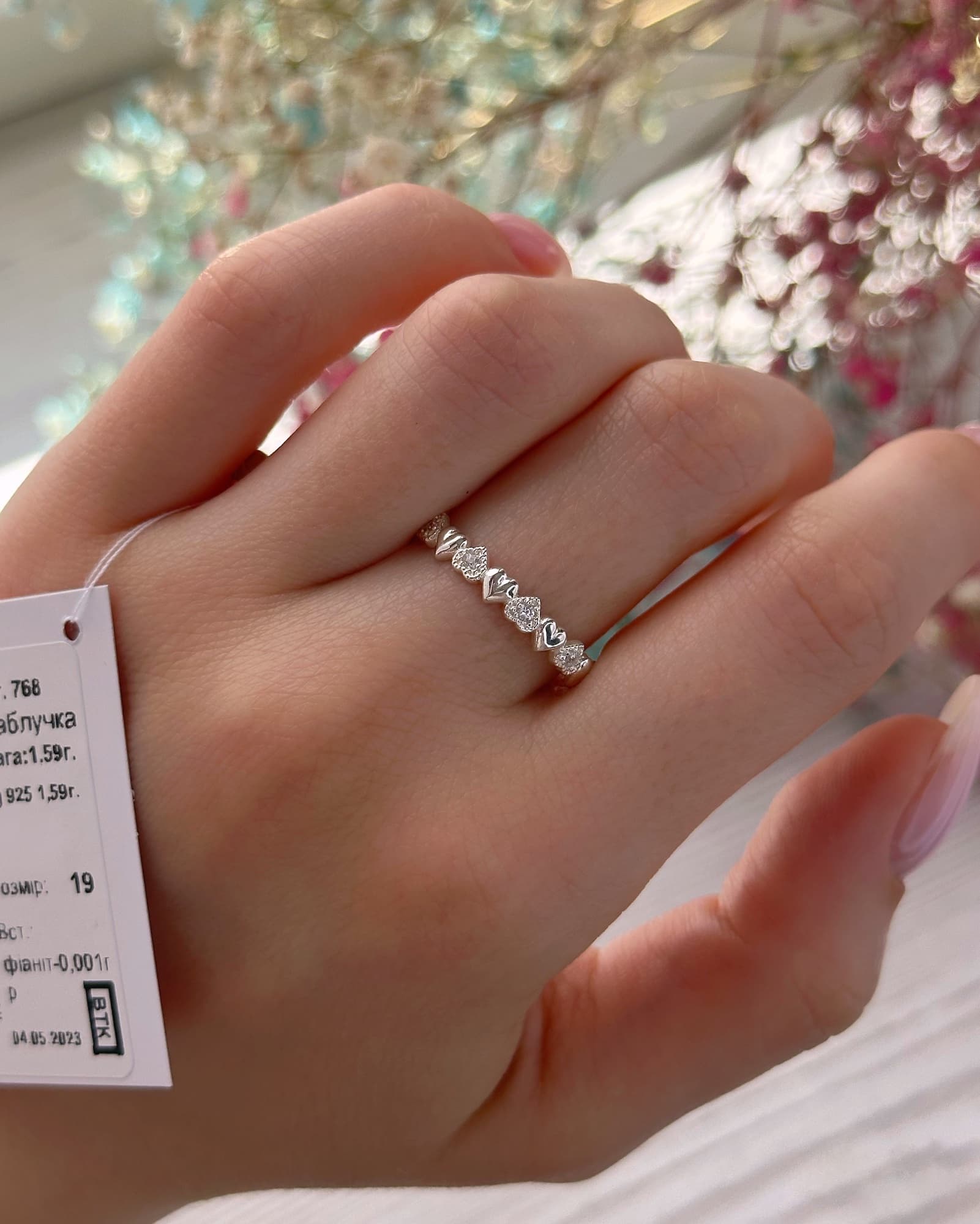 Rhodium-plated silver ring with a row of hearts and stones