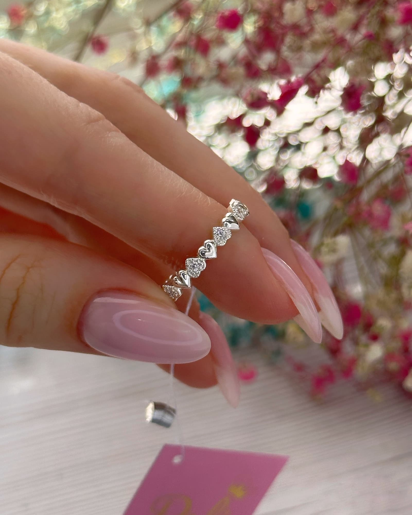 Rhodium-plated silver ring with a row of hearts and stones