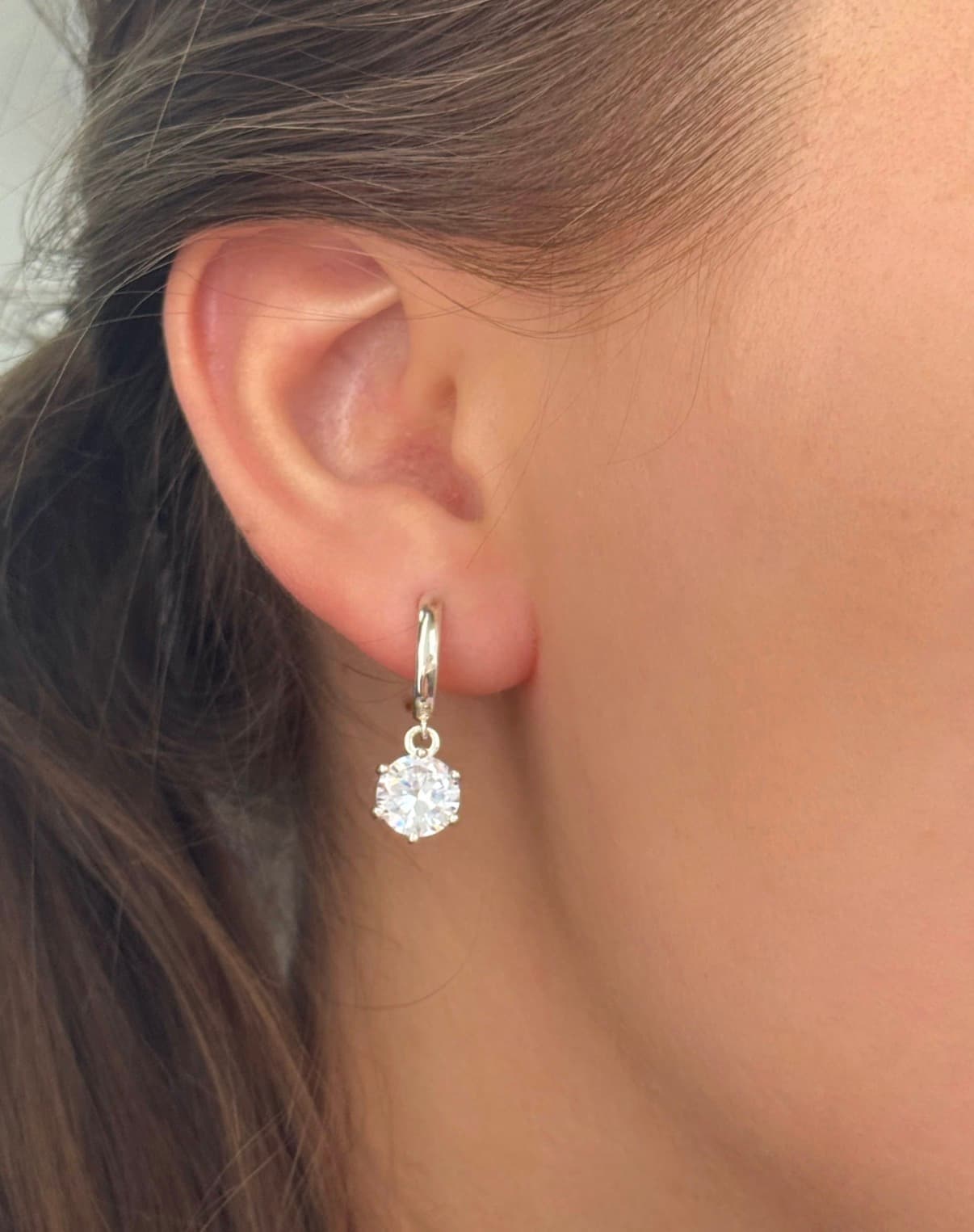 Silver earrings with round cubic zirconia drops on hoops