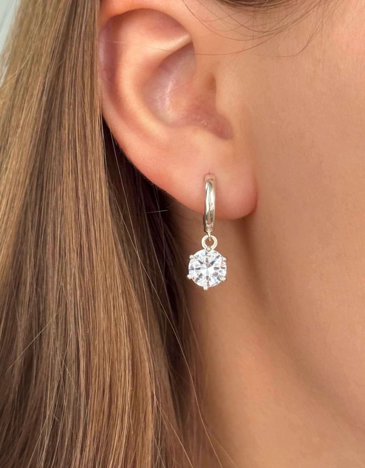 Silver earrings with round cubic zirconia drops on hoops