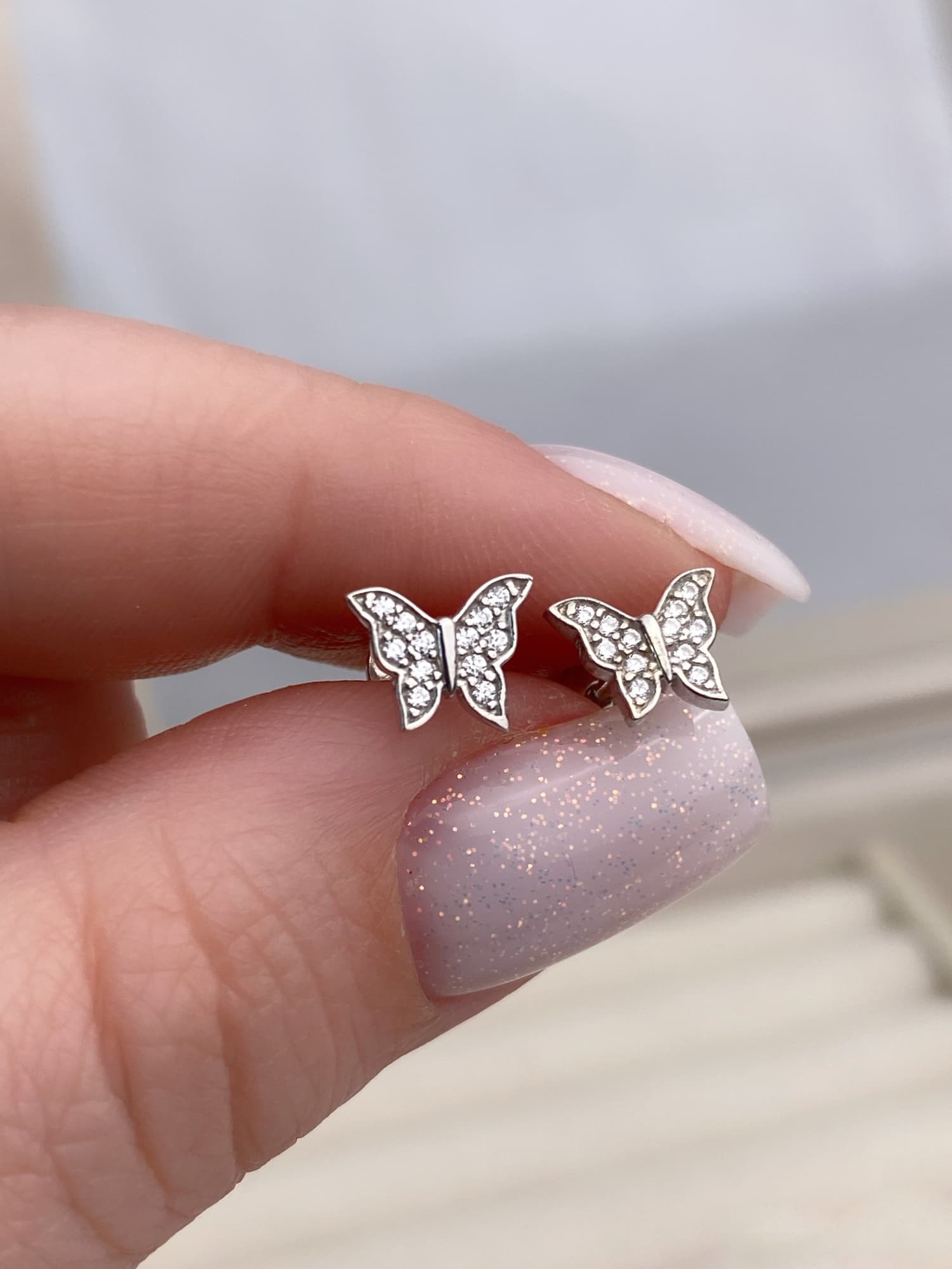 Rhodium-plated silver butterfly stud earrings with cubic zirconia