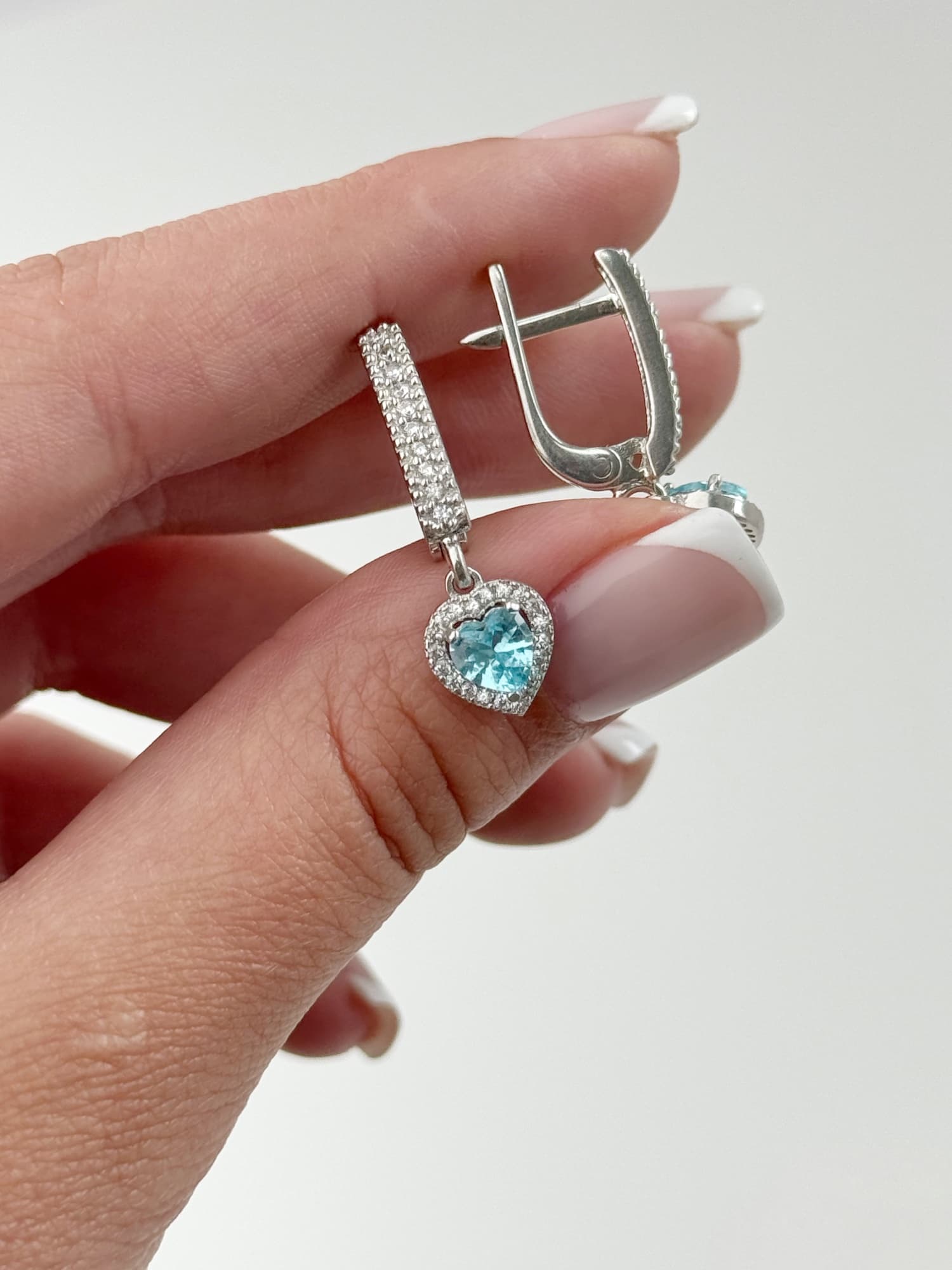 Silver “Hearts” earrings on an English lock with a light blue heart-shaped cubic zirconia