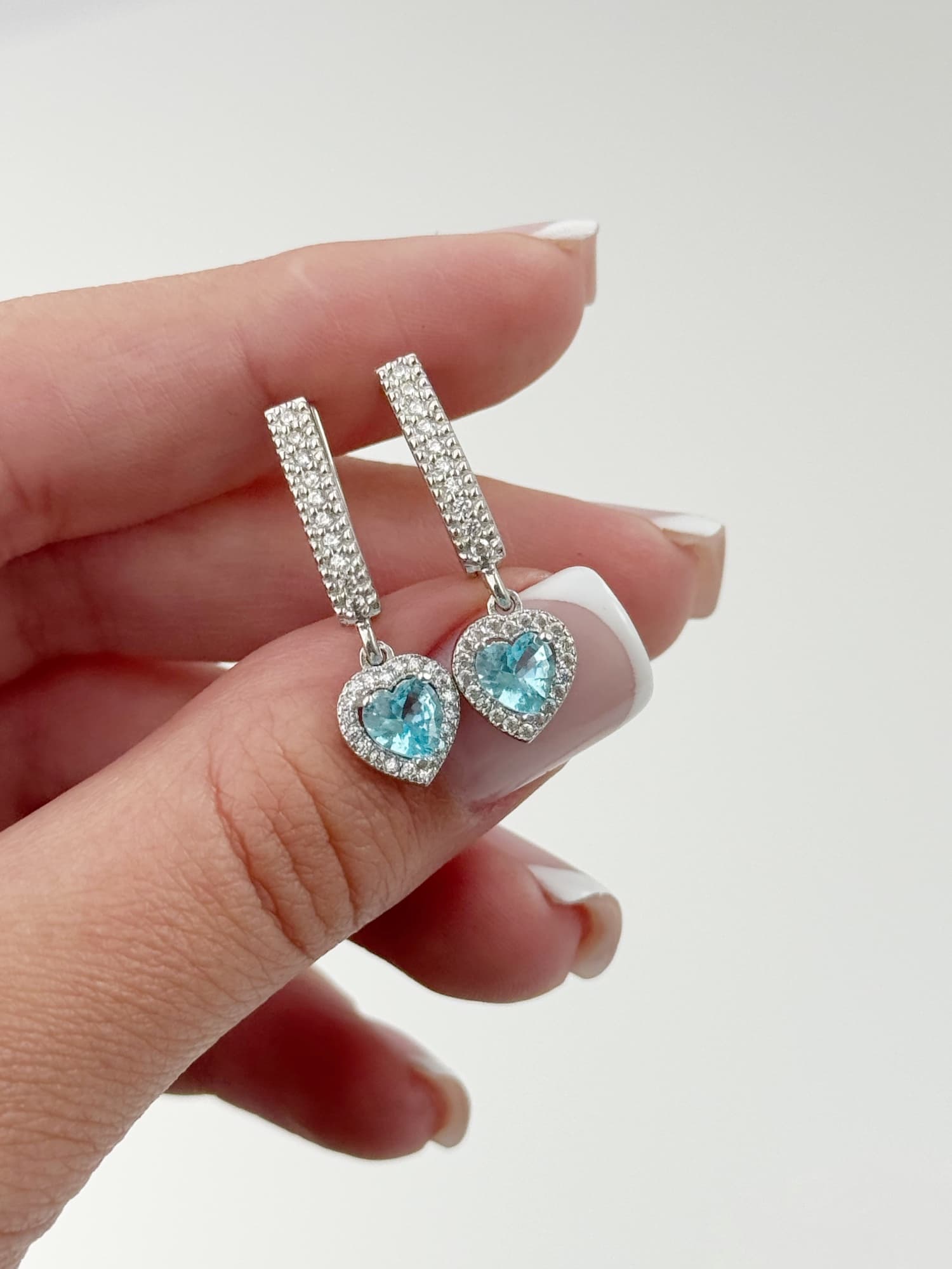 Silver “Hearts” earrings on an English lock with a light blue heart-shaped cubic zirconia